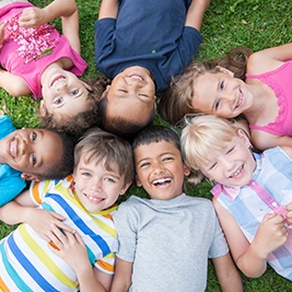 Smiling group of kids on lawn