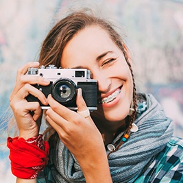 Teen girl with braces taking photo