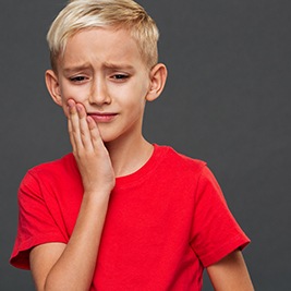 Grimacing little boy with a toothache
