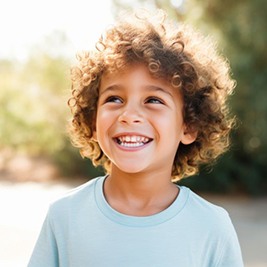 Happy child standing outdoors