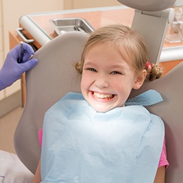 Child smiling in dental chair
