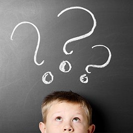 Young boy with question marks over his head