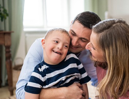 Child with special needs smiling at parents