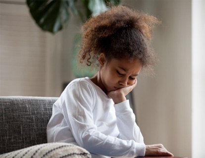 Closeup of child experiencing toothache