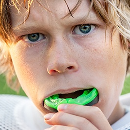 Teen boy placing green sportsguard