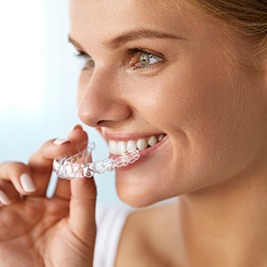 Woman placing Invisalign tray