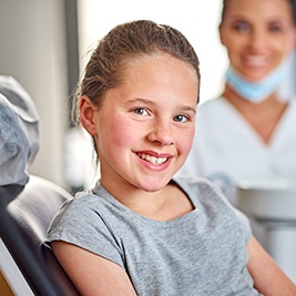 Smiling girl in dental chair