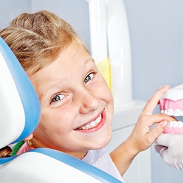 Smiling girl in dental chair