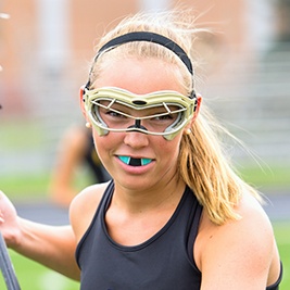 Teen girl playing lacrosse