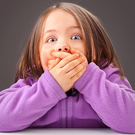 Child covering her mouth