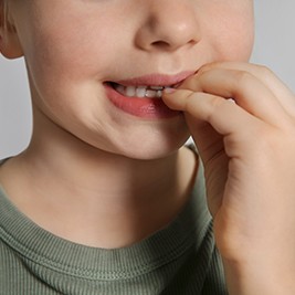 Closeup of child biting their nails