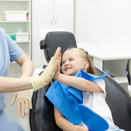 Girl giving high five to her dentist