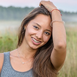 Teen girl with braces smiling outdoors