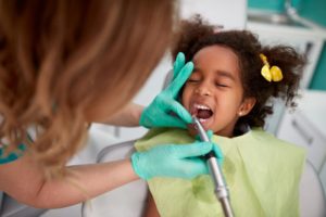 Little girl visiting her pediatric dentist for checkup