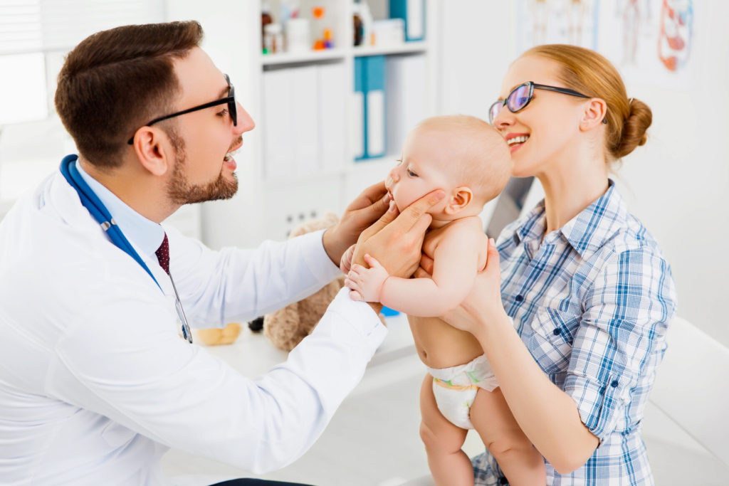 mom learning about tongue tie issues in Auburn with baby at dentist