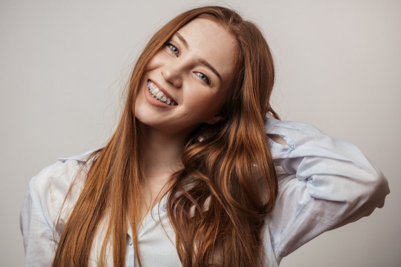 A red-headed young woman wearing braces