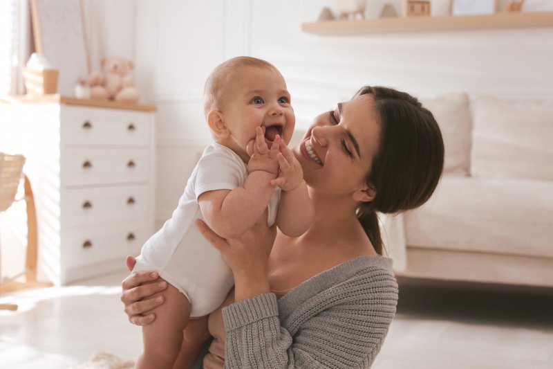 A woman and her baby smiling after breastfeeding