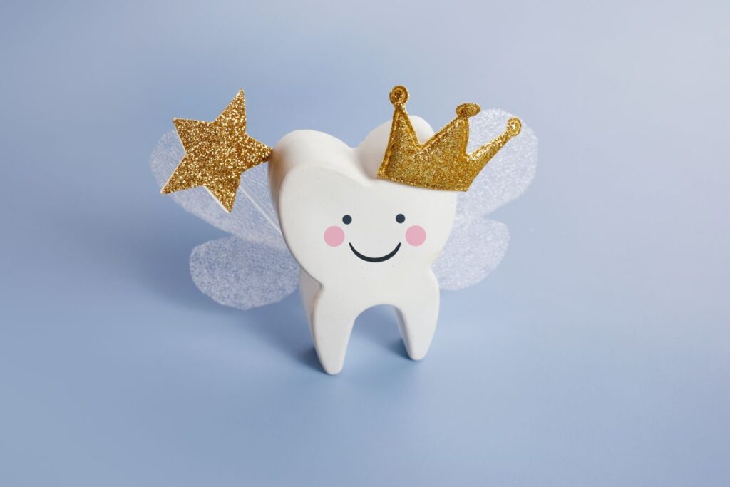 A wooden tooth with fairy wings and a wand.