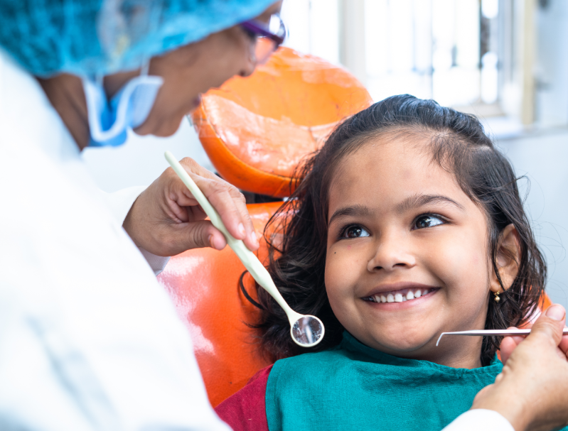 Child smiling in dental chair